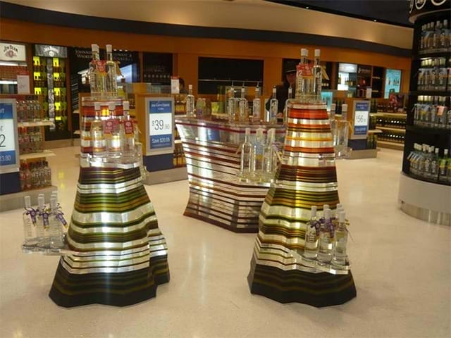 Layered acrylic stands for airport duty free store - stunning! - Displays2Go