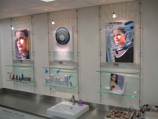 Wall display system with clear shelves and wire supports - Displays2Go